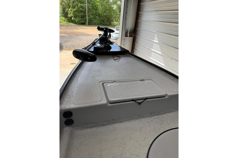 Slide: The Image of 2026 Santee 160 Center Console boat deck with storage hatch and trolling motor. - 5