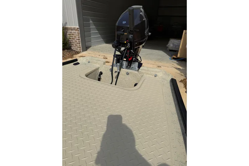 Slide: The Image of 2026 Santee 160 Tiller Steer boat with motor, parked in a garage. - 3