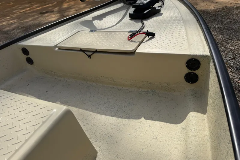 Slide: The Image of 2026 Santee 160 Tiller Steer boat interior with storage compartment and wiring details. - 4