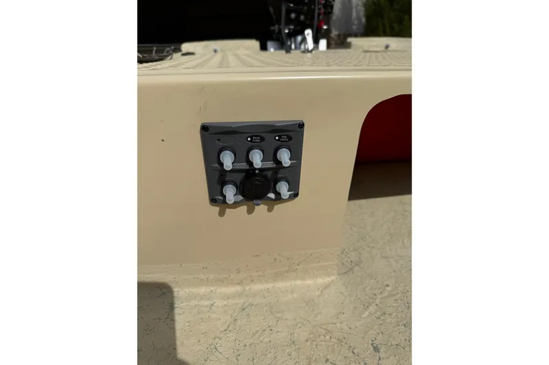 Slide: The Image of Control panel on a 2026 Santee 160 Tiller Steer boat, featuring switches and knobs. - 7