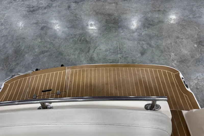 Slide: The Image of 2006 Rinker Fiesta Vee 250 boat deck with wood finish and railing. - 10