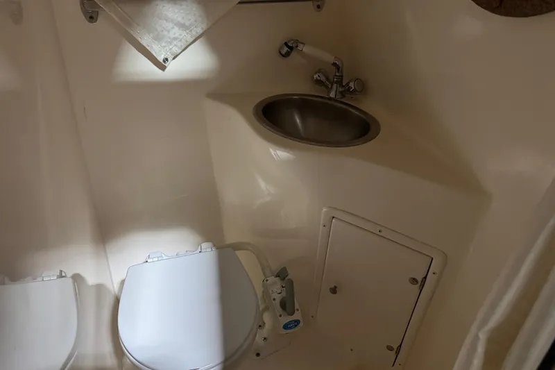 Slide: The Image of 2006 Rinker Fiesta Vee 250 boat bathroom with toilet and sink. - 15