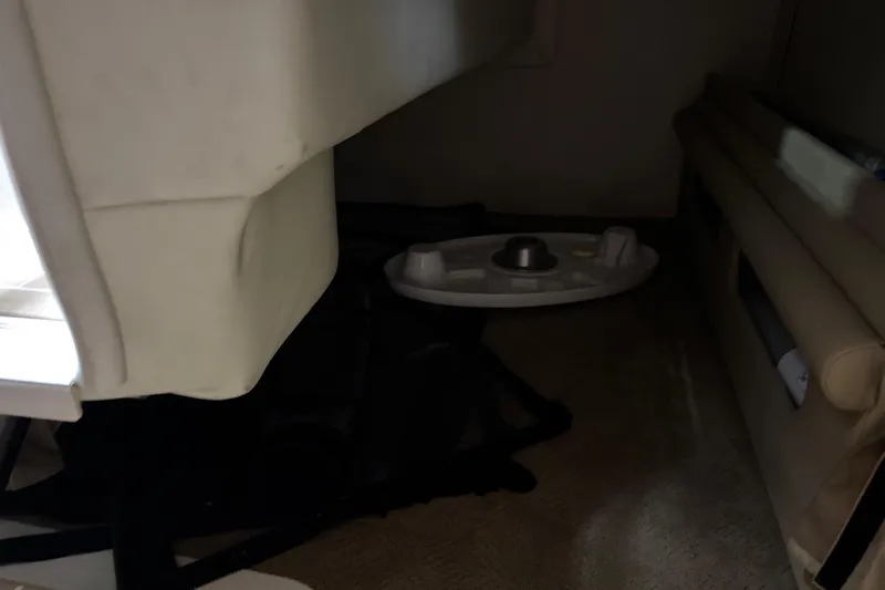 Slide: The Image of Interior of a 2006 Rinker Fiesta Vee 250 boat, featuring seating and storage area. - 16