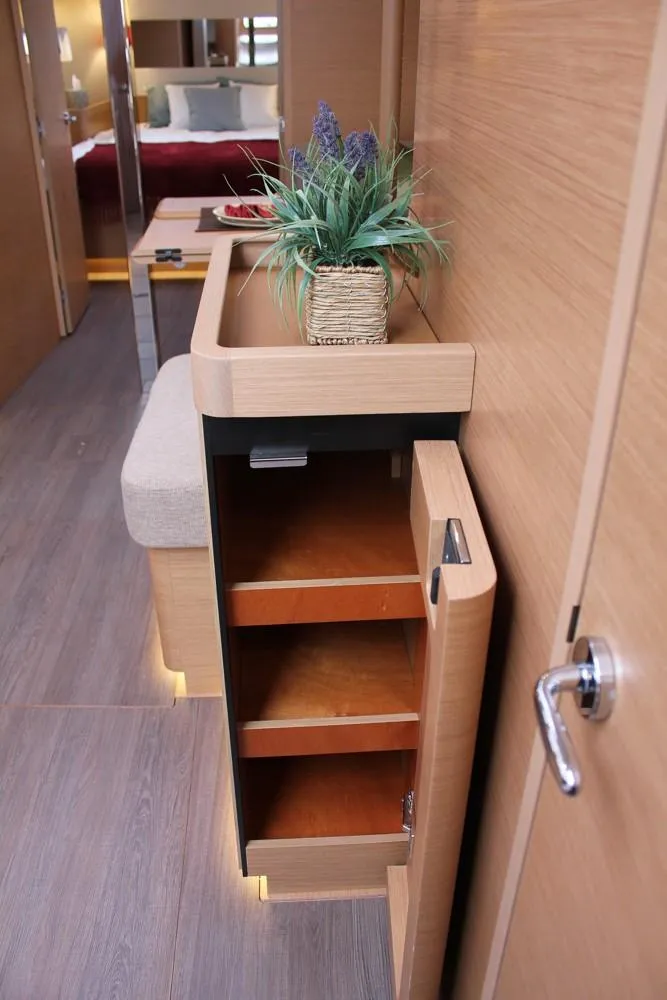Slide: The Image of Interior of 2025 Jeanneau Sun Odyssey 440 yacht with modern wooden cabinetry and decor. - 22