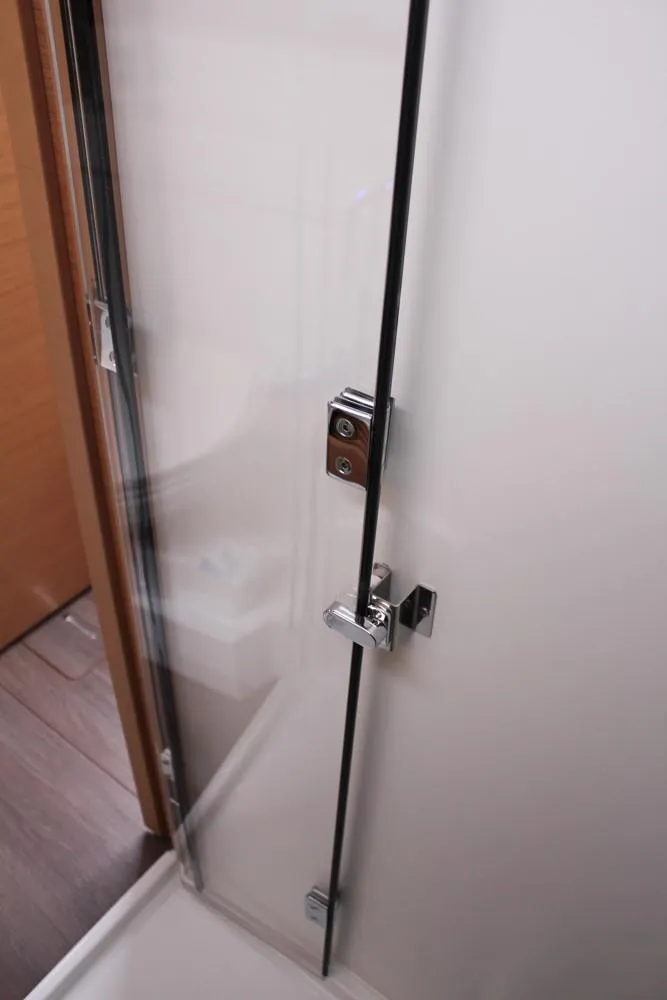 Slide: The Image of 2025 Jeanneau Sun Odyssey 440 shower door with sleek chrome handle. - 27