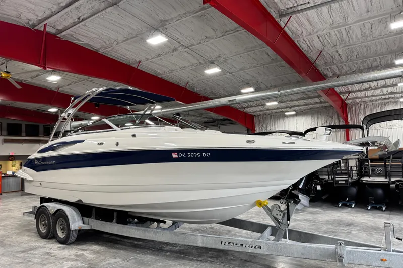The Image of 2008 Crownline 300 LS boat on trailer in indoor storage facility. - 1