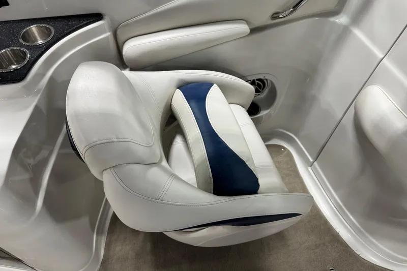 Slide: The Image of 2008 Crownline 300 LS boat interior with white and blue seating and cup holders. - 11