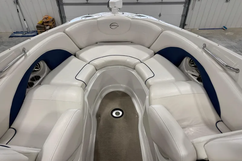 Slide: The Image of 2008 Crownline 300 LS boat interior with white and blue seating in a garage. - 13