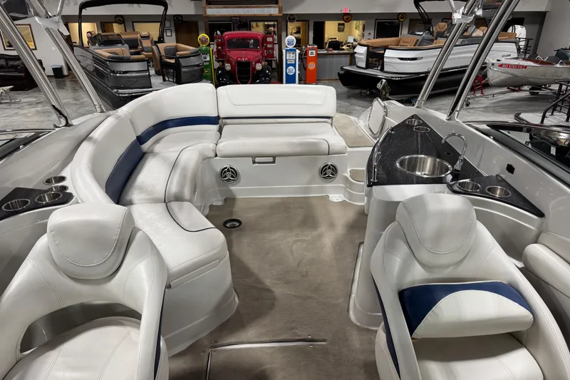 Slide: The Image of Interior of a 2008 Crownline 300 LS boat with white seating and a sleek design. - 15