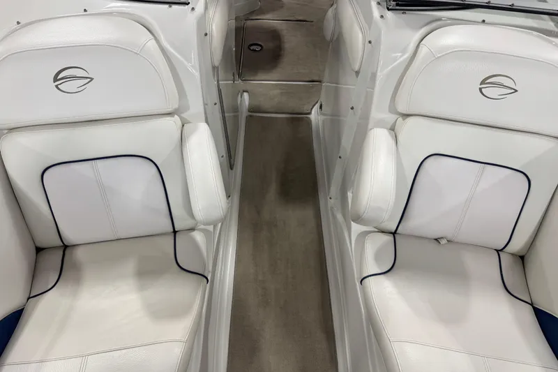 Slide: The Image of 2008 Crownline 300 LS boat interior with white leather seating and carpeted floor. - 16