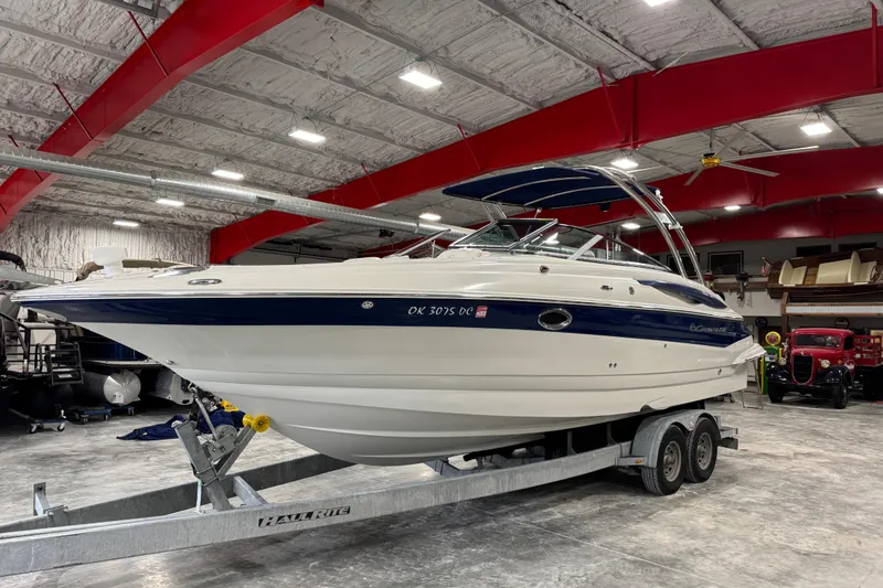 Slide: The Image of 2008 Crownline 300 LS boat on trailer in indoor storage facility. - 2