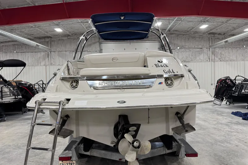 Slide: The Image of 2008 Crownline 300 LS boat in storage, rear view with ladder and propeller. - 5