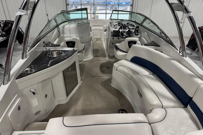 Slide: The Image of 2008 Crownline 300 LS boat interior with white seating and kitchenette. - 8