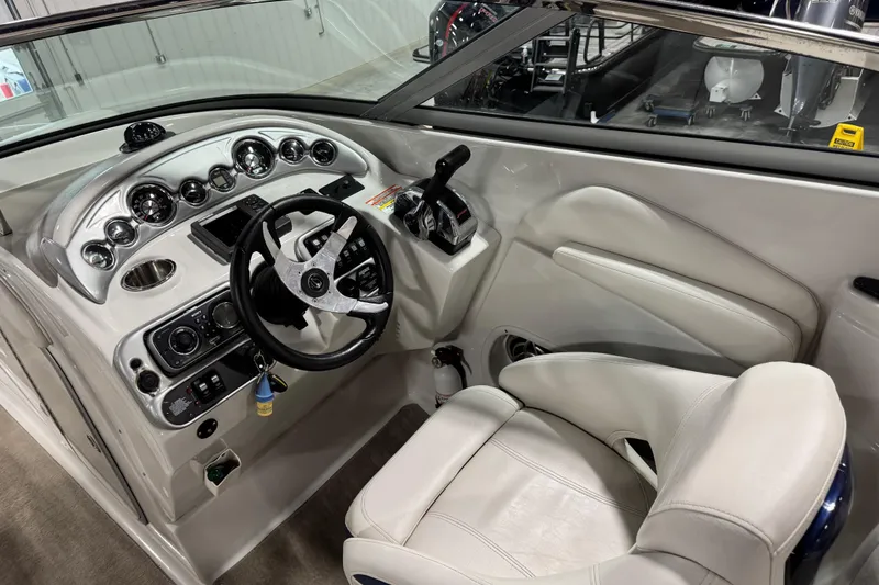 Slide: The Image of 2008 Crownline 300 LS boat cockpit with steering wheel and control panel. - 9