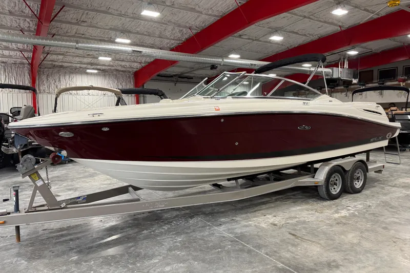 The Image of 2006 Sea Ray 270 SLX boat on trailer in indoor storage facility. - 1