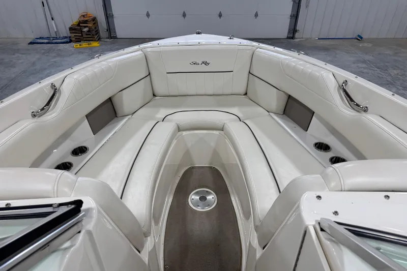 Slide: The Image of 2006 Sea Ray 270 SLX boat interior with white leather seating and cup holders. - 10