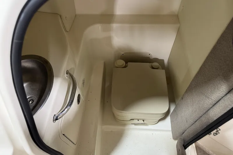 Slide: The Image of 2006 Sea Ray 270 SLX boat interior with compact toilet and sink. - 12