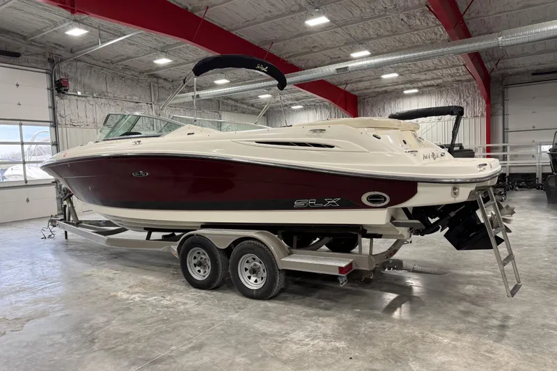 Slide: The Image of 2006 Sea Ray 270 SLX boat on trailer in indoor storage facility. - 3