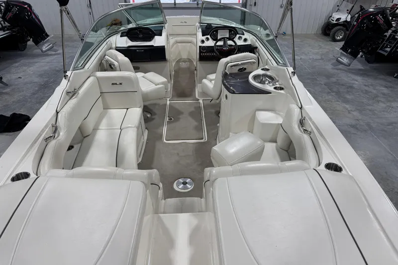 Slide: The Image of 2006 Sea Ray 270 SLX boat interior with white seating and modern dashboard. - 5