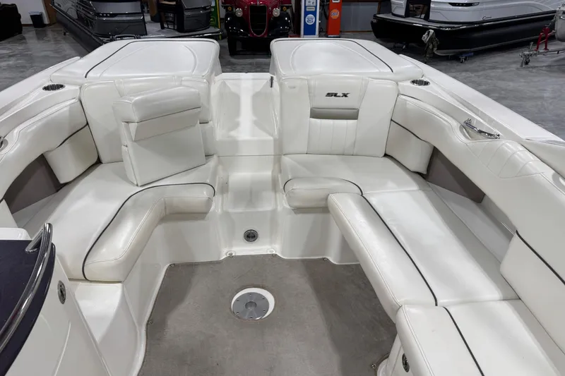 Slide: The Image of Interior of a 2006 Sea Ray 270 SLX boat with white seating and sleek design. - 6