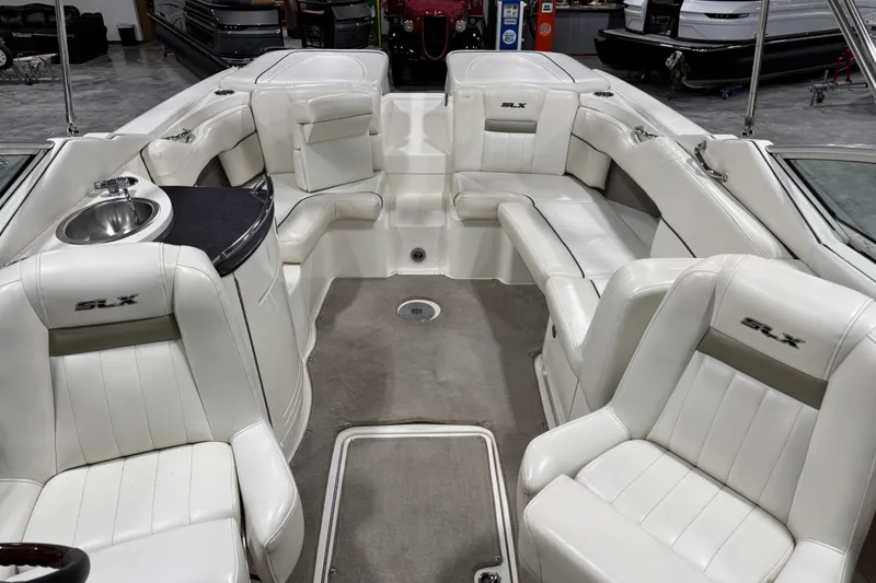 Slide: The Image of 2006 Sea Ray 270 SLX boat interior with white leather seating and built-in sink. - 7