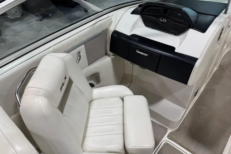 Slide: The Image of 2006 Sea Ray 270 SLX boat interior with white seating and dashboard. - 8