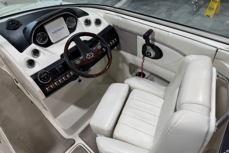 Slide: The Image of Interior view of 2006 Sea Ray 270 SLX boat cockpit with steering wheel and controls. - 9