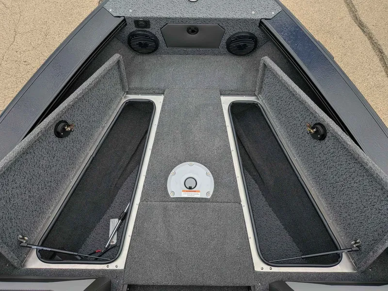 Slide: The Image of Interior view of 2026 Lund 1875CROSSOVERXS boat deck with storage compartments. - 13