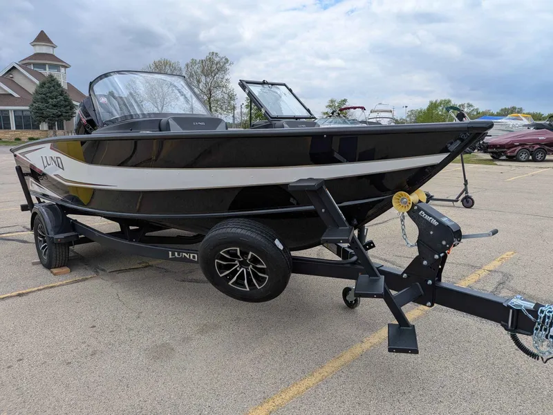 Slide: The Image of 2026 Lund 1875CROSSOVERXS boat parked on trailer outdoors. - 15