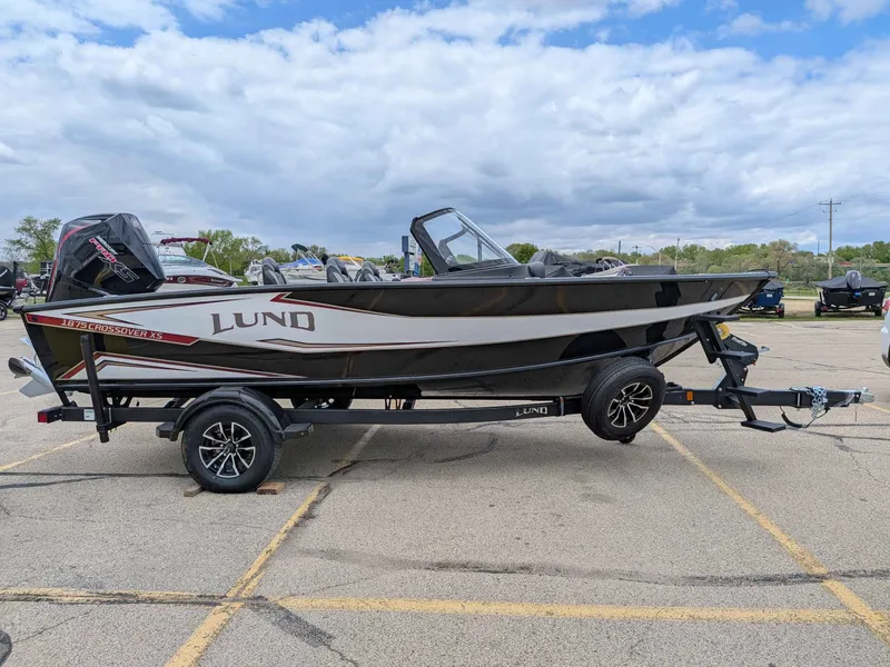 Slide: The Image of 2026 Lund 1875CROSSOVERXS boat parked on trailer outdoors. - 16