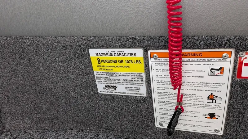 Slide: The Image of Lund 1875CROSSOVERXS 2026 boat capacity label and safety warning. - 18