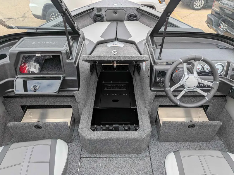 Slide: The Image of Interior of 2026 Lund 1875CROSSOVERXS with steering wheel and storage compartments. - 9