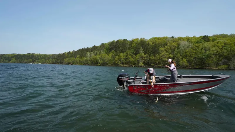 The Image of 2026 Lund 1875 Pro Guide boat on a lake during fishing. - 1