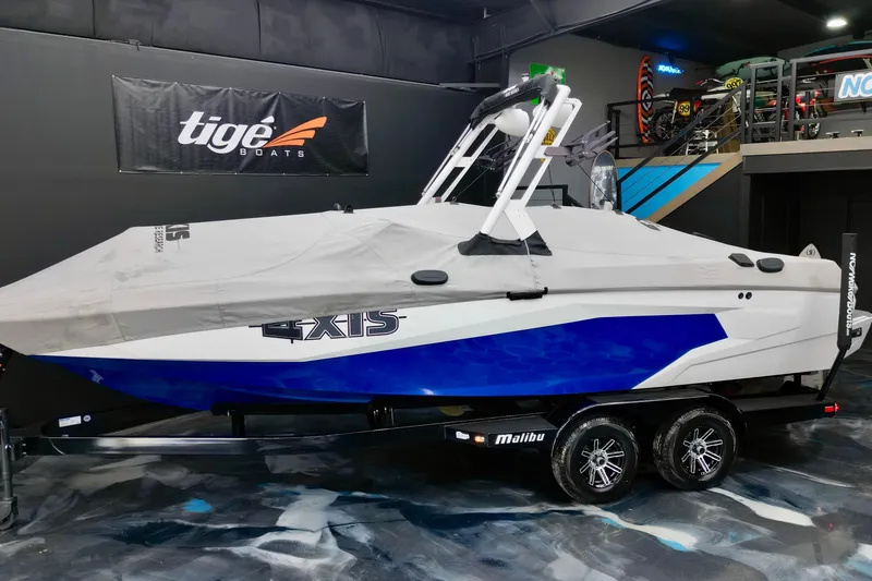 Slide: The Image of 2023 Axis A225 boat with cover on trailer in showroom. - 14