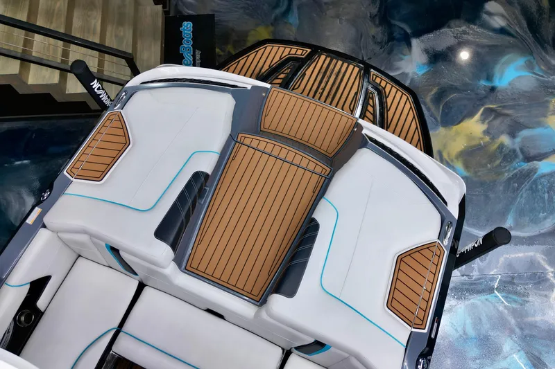 Slide: The Image of 2014 Nautique Super Air Nautique G21 boat interior with teak accents and white seating. - 10