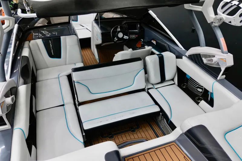 Slide: The Image of 2014 Nautique Super Air Nautique G21 interior with white seating and modern dashboard. - 13