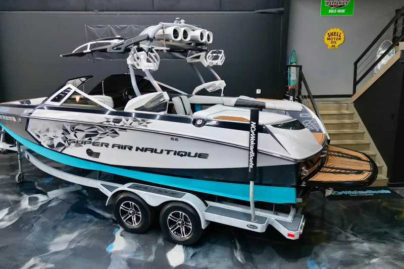 Slide: The Image of 2014 Nautique Super Air Nautique G21 boat on trailer in showroom. - 2
