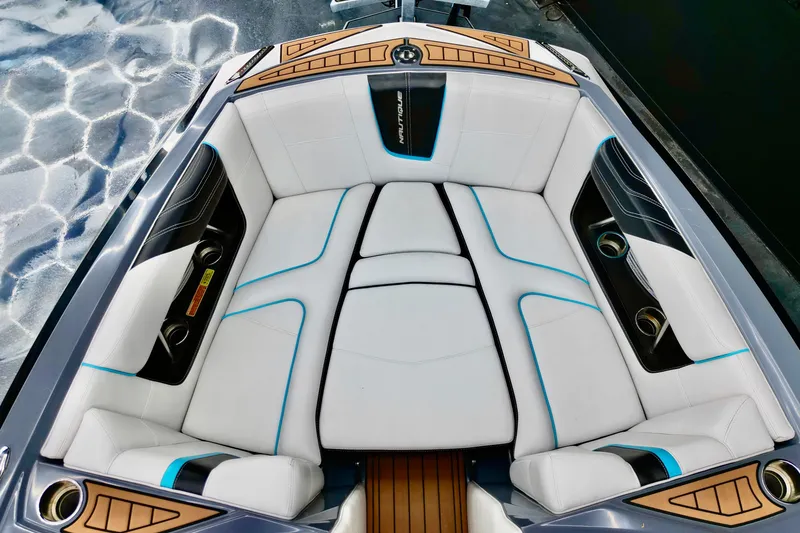 Slide: The Image of 2014 Nautique Super Air Nautique G21 boat interior with white seating and blue accents. - 4