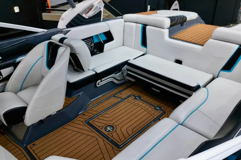 Slide: The Image of 2014 Nautique Super Air Nautique G21 interior with luxurious seating and teak flooring. - 5