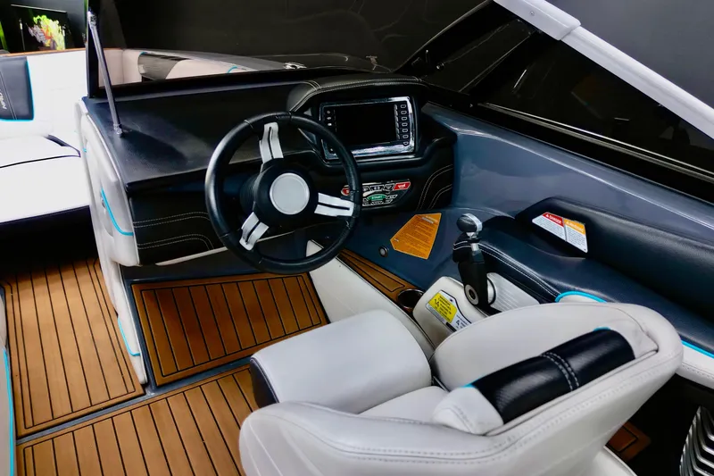 Slide: The Image of Interior of 2014 Nautique Super Air Nautique G21 boat, featuring sleek dashboard and steering wheel. - 6