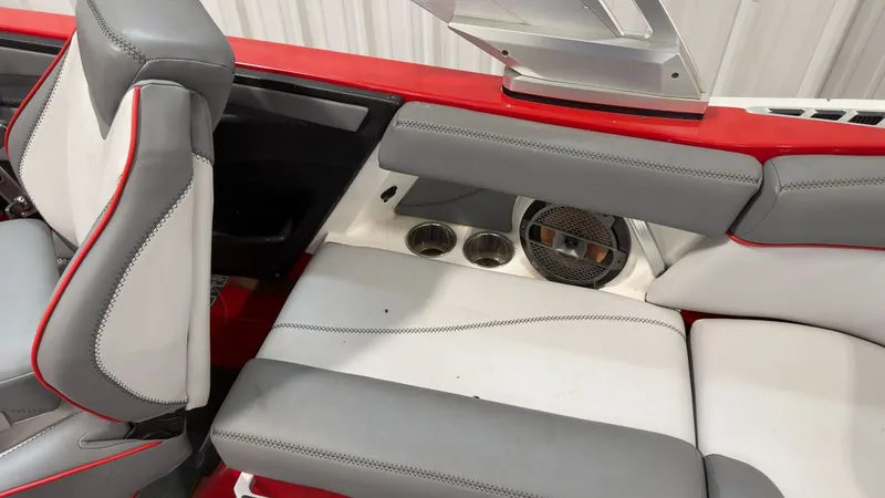 Slide: The Image of Interior of a 2019 MasterCraft XT20 boat with gray and red seating. - 10