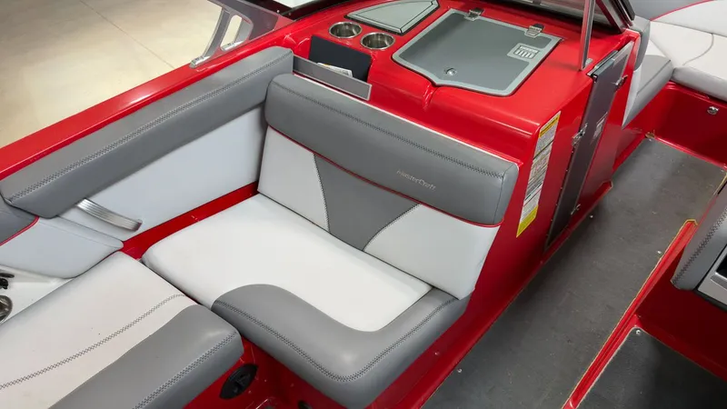 Slide: The Image of Interior of a 2019 MasterCraft XT20 boat with red and gray seating. - 11