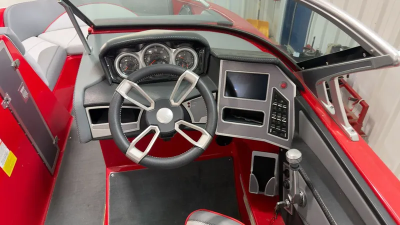 Slide: The Image of Interior of a 2019 MasterCraft XT20 boat with red dashboard. - 13