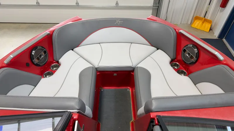 Slide: The Image of Interior of a 2019 MasterCraft XT20 boat with gray and red seating. - 16