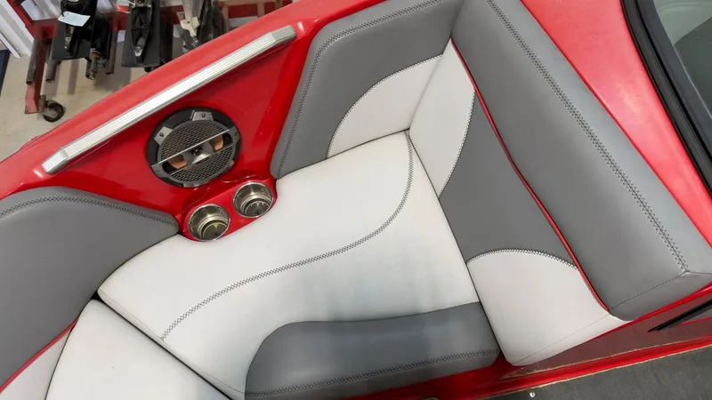 Slide: The Image of Interior of a 2019 MasterCraft XT20 boat with red and gray seating. - 17
