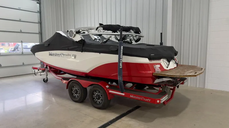 Slide: The Image of 2019 MasterCraft XT20 boat in warehouse on trailer. - 19