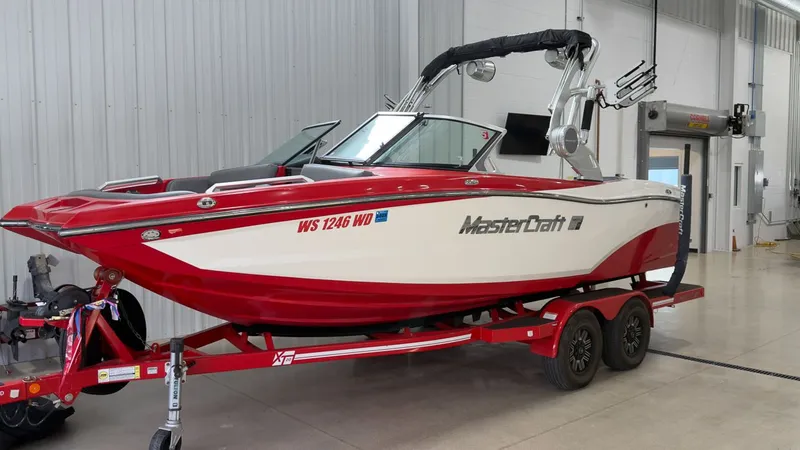 Slide: The Image of 2019 MasterCraft XT20 boat in red and white color scheme. - 2