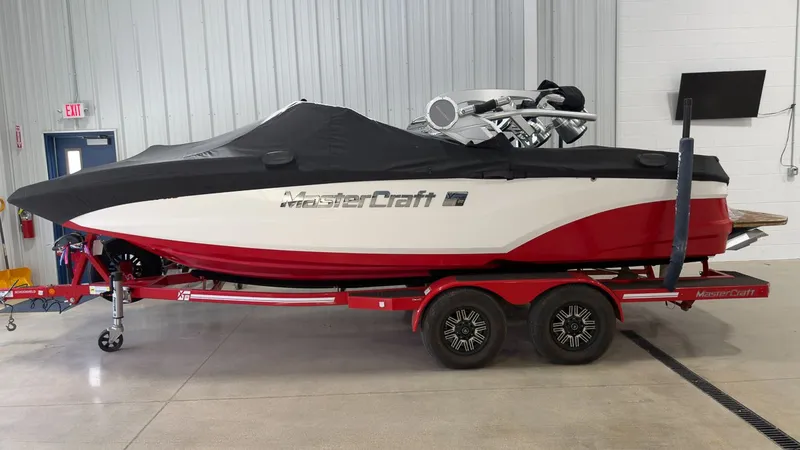 Slide: The Image of 2019 MasterCraft XT20 boat on trailer in warehouse. - 20