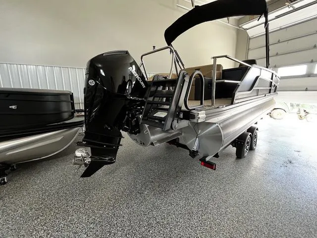 Slide: The Image of Evotti 523CS 2026 pontoon boat with outboard motor in a garage. - 4