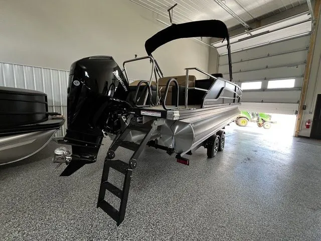 Slide: The Image of Evotti 523CS 2026 pontoon boat in garage with outboard motor. - 5
